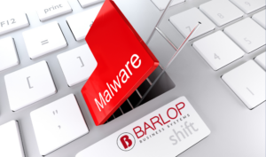 Malware warning sign on keyboard with Barlop Business Systems logo, emphasizing cybersecurity awareness and prevention.